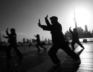 photo of the silhouettes of people doing exercise movements
