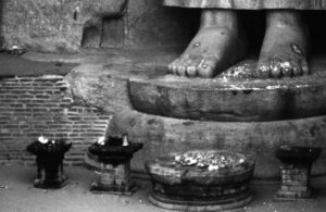 offerings at a statue's feet