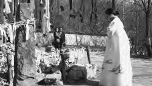 a woman prays at a shrine