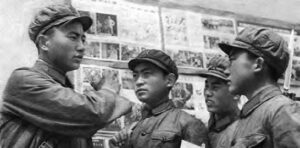 four young boys in military uniform speaking to each other