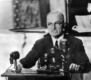 a man sits at a desk in front of a microphone