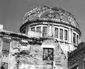 the structure of a building with a dome remains. it is heavily damaged and is only a shell of a building.