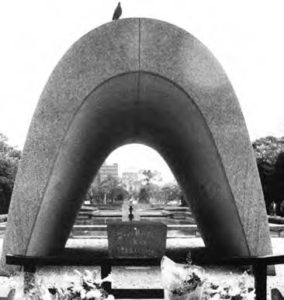 A domed building can be seen in the distance behind a large archway.