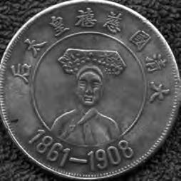 a coin with a woman on it, with the year 1961-1908