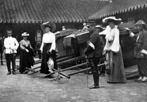 photo of women in dresses and men in military uniforms