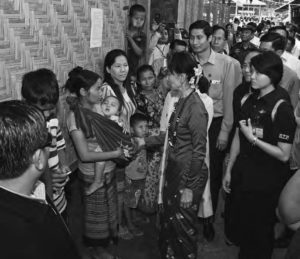 photo of woman meeting with another younger one, while many people look on