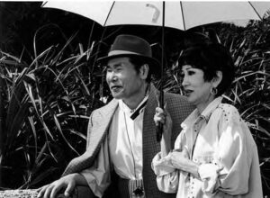 a man and woman share an umbrella