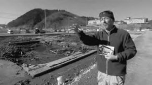 a man standing in front of an empty plot of land where a building once stood