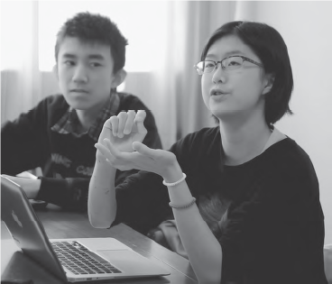 photo of a girl speaking while a boy next to her looks at her