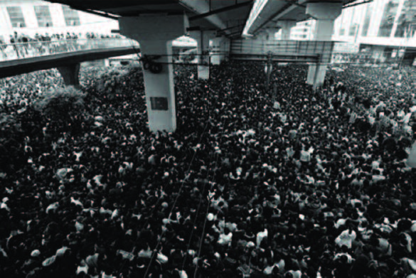 Guangzhou Train Station at New Year’s. A sea of people crowd the train station platform. 