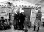 poeple standing in front of a yurt