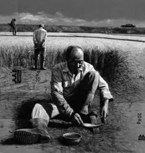 a man sitting sharpening his blade