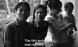 a photo of several women speaking. the screen caption says "the film technique was not very good"