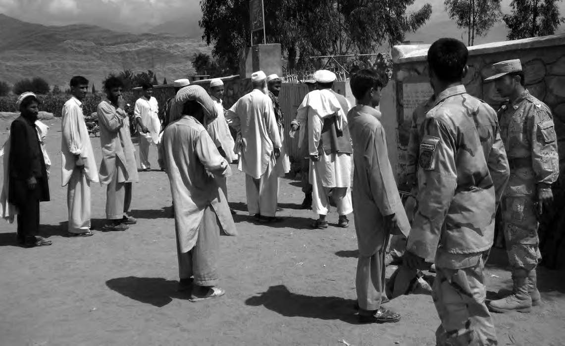 photo of several men next to military men