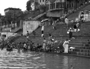 people stand on the steps at the edge of water where people swim
