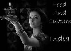 a woman holds a candle, next to the text "food and culture india"