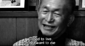 an old man speaking, with the screen caption: "i wanted to live. I didn't want to die."