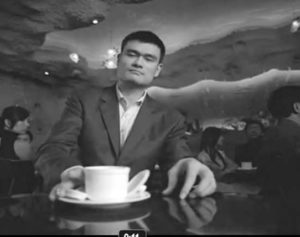 photo of a man in a suit drinking coffee